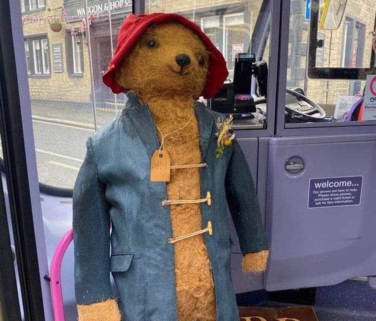 Paddington bear on his travels again as he arrives for Lindley Scarecrow Festival – on a bus