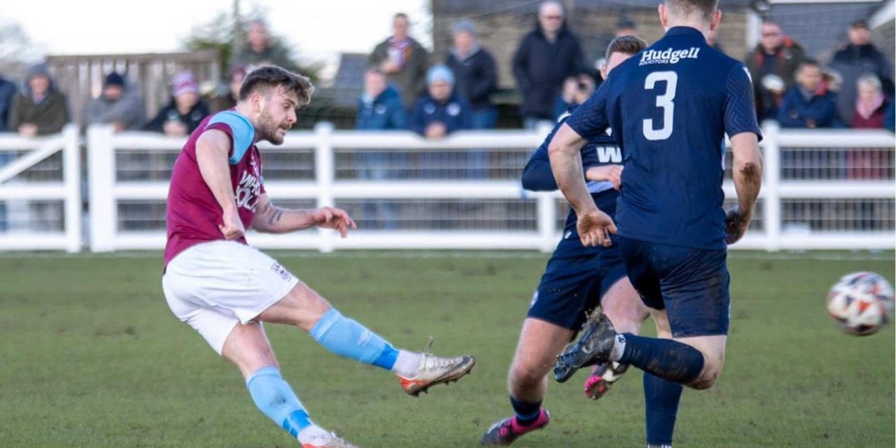 Alex Metcalfe scored the pick of the goals as Emley AFC press on at the top