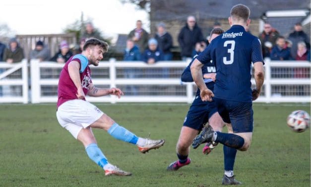 Alex Metcalfe scored the pick of the goals as Emley AFC press on at the top