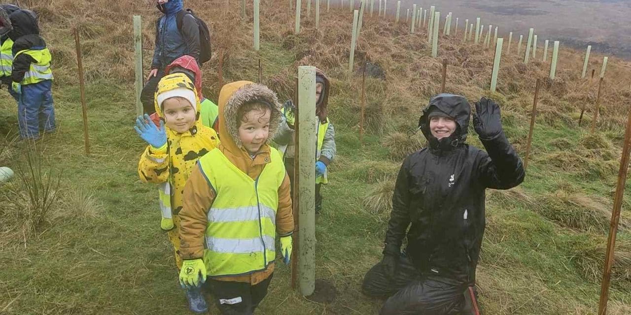 Youngsters help plant new trees in woodland on the edge of Marsden Moor