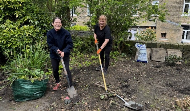 Staff from Ridley & Hall Solicitors dig in to help transform garden at Edgerton day centre